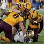 Arizona State defensive players Merlin Robertson (8) D.J Davidson (98) and Darien Butler (20) smother Colorado State tailback Alex Fontenot (8) during the first half of an NCAA college football game Sat, Sept 25, 2021, in Tempe, Ariz. (AP Photo/Darryl Webb)