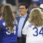 Former Los Angeles Dodgers pitcher Fernando Valenzuela, center, greets his family as he is honored before a baseball game between the Arizona Diamondbacks and the Los Angeles Dodgers Wednesday, Sept. 15, 2021, in Los Angeles. (AP Photo/Ashley Landis)