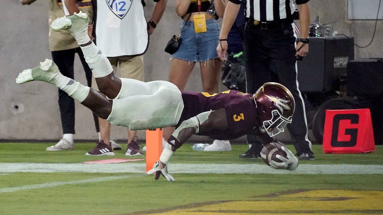 Arizona State running back Rachaad White (3) scores a touchdown against UNLV during the second half...