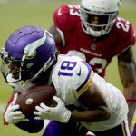 Minnesota Vikings wide receiver Justin Jefferson (18) makes a catch has Arizona Cardinals cornerback Robert Alford (23) defends during the second half of an NFL football game, Sunday, Sept. 19, 2021, in Glendale, Ariz. (AP Photo/Ross D. Franklin)