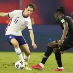 United States forward Brenden Aaronson (11) dribbles against Canada defender Sam Adekugbe, right, during the first half of a World Cup soccer qualifier Sunday, Sept. 5, 2021, in Nashville, Tenn. (AP Photo/Mark Humphrey)