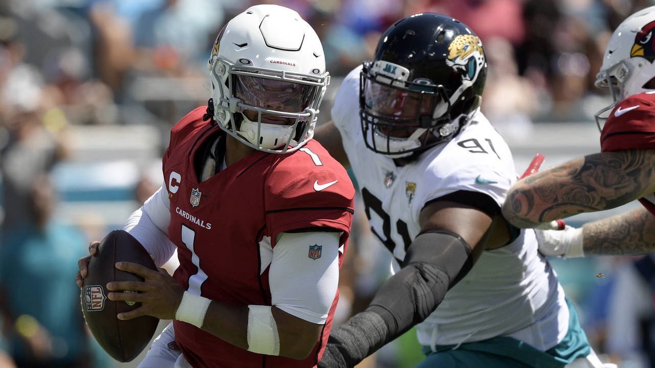 Arizona Cardinals quarterback Kyler Murray (1) scrambles way from Jacksonville Jaguars defensive en...