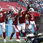 Arizona Cardinals defensive end J.J. Watt (99) celebrates after teammate Corey Peters, third from left, recovered a Tennessee Titans fumble in the first half of an NFL football game Sunday, Sept. 12, 2021, in Nashville, Tenn. (AP Photo/Wade Payne)