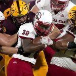 Southern Utah running back David Moore III (30) is stopped by Arizona State defensive lineman D.J. Davidson (98) and defensive end Michael Matus (91) during the first half of an NCAA college football game, Thursday, Sept. 2, 2021, in Tempe, Ariz. (AP Photo/Matt York)