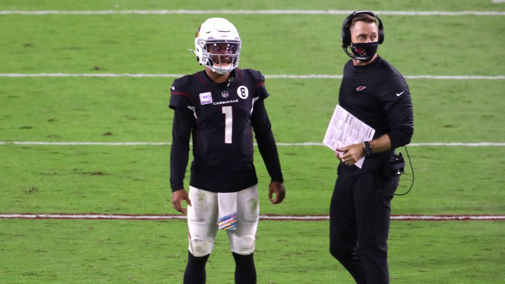 Head coach Kliff Kingsbury of the Arizona Cardinals and quarterback Kyler Murray #1 look on from th...