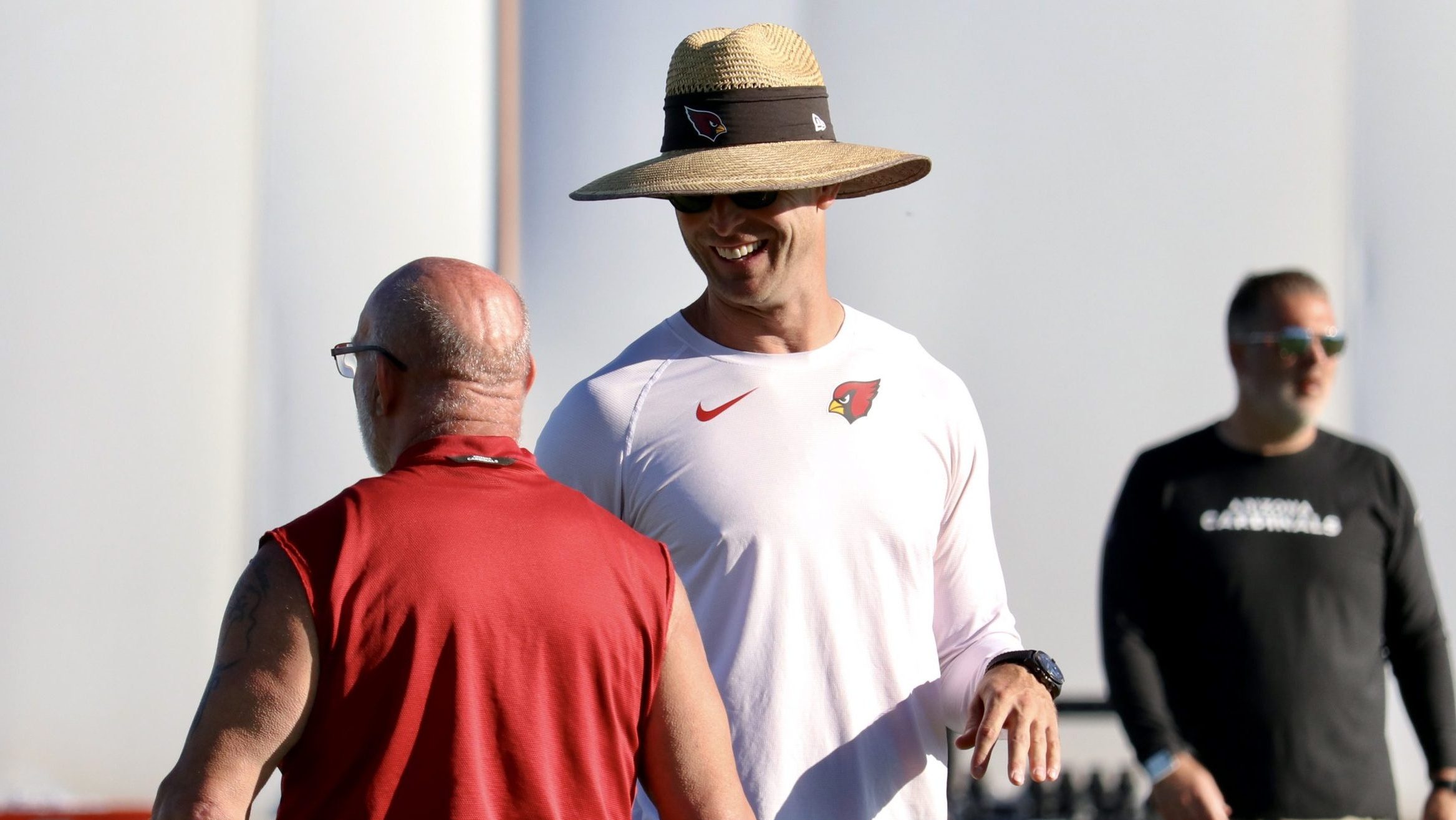 Arizona Cardinals head coach Kliff Kingsbury laughs with strength and conditioning coach Buddy Morr...
