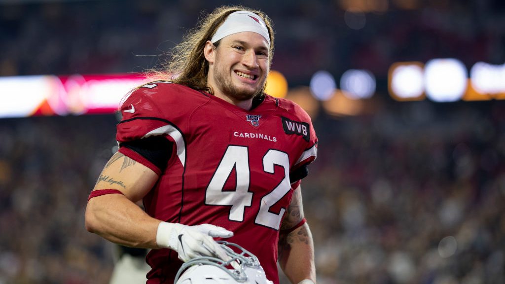 Linebacker Dennis Gardeck #42 of the Arizona Cardinals smiles while running off the field after the...