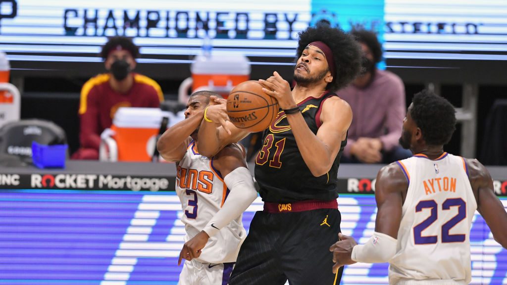 Chris Paul #3 of the Phoenix Suns fights for a rebound against Jarrett Allen #31 of the Cleveland C...