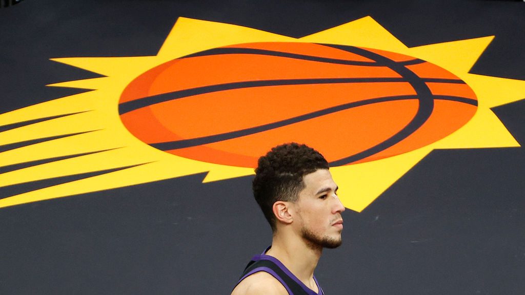 A dejected Devin Booker #1 of the Phoenix Suns leaves the court following the team's loss to the LA...