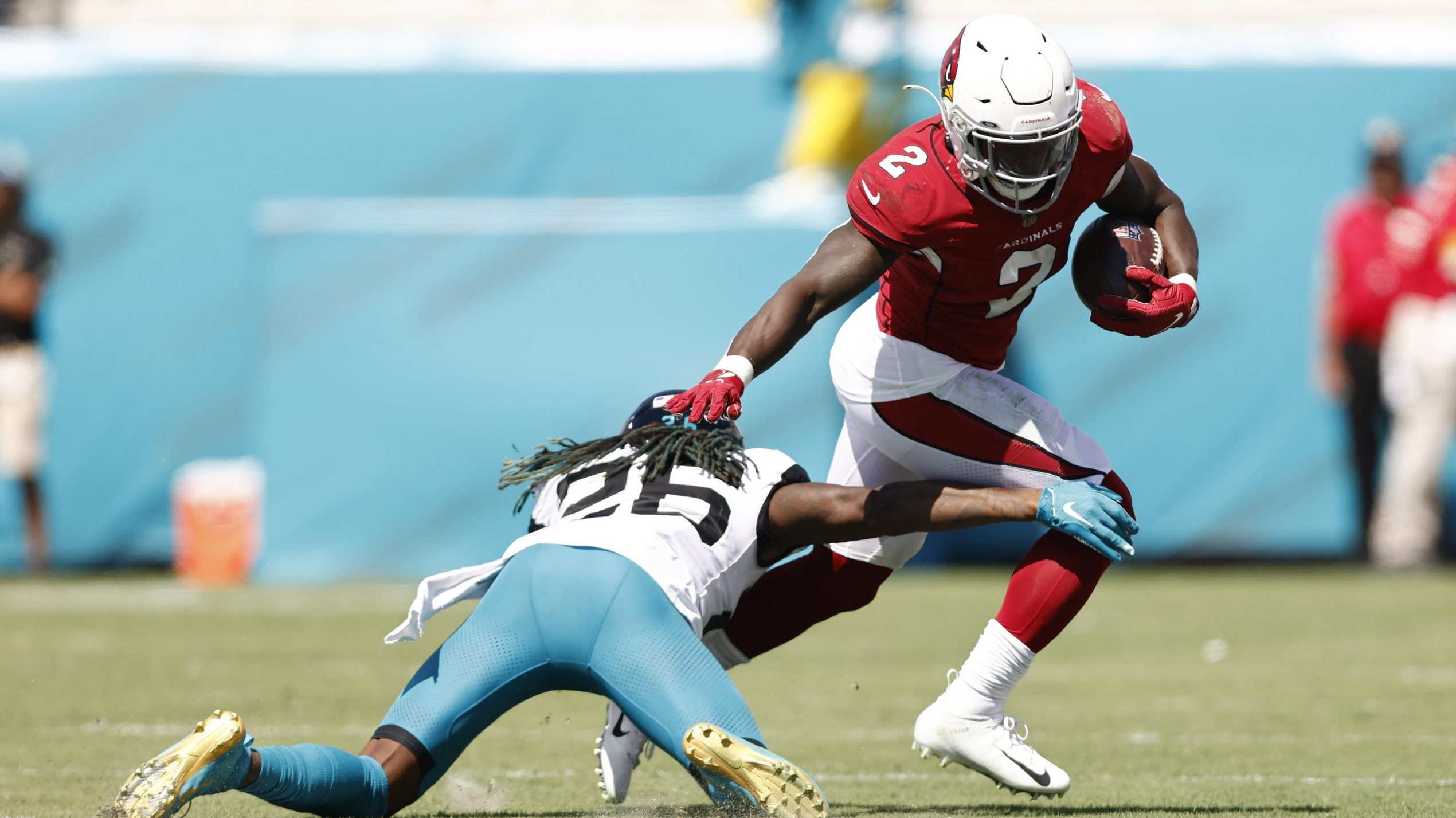Chase Edmonds #2 of the Arizona Cardinals breaks a tackle by Shaquill Griffin #26 of the Jacksonvil...