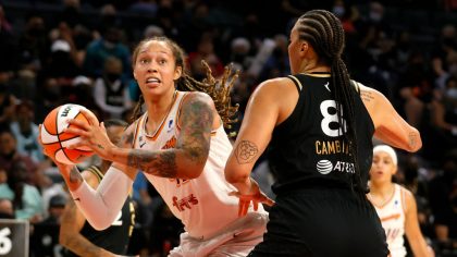Brittney Griner #42 of the Phoenix Mercury drives to the basket against Liz Cambage #8 of the Las V...
