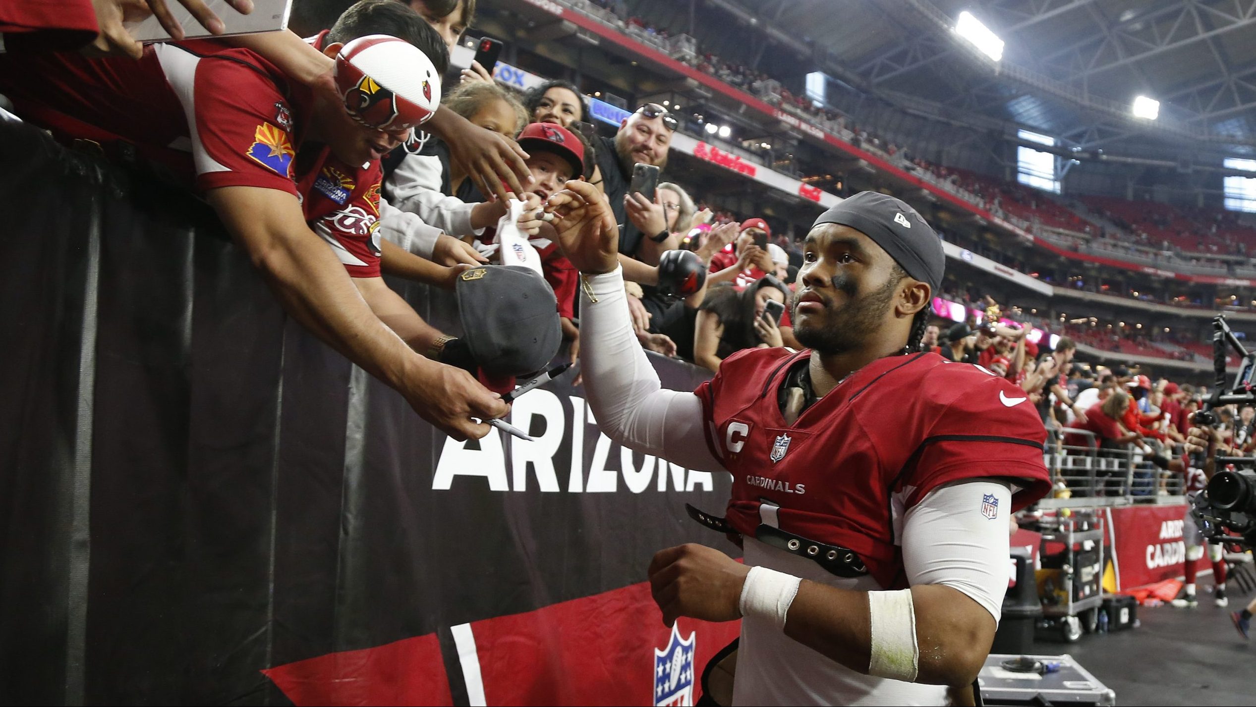 Kyler Murray #1 of the Arizona Cardinals celebrates with fans after beating the Houston Texans 31-5...