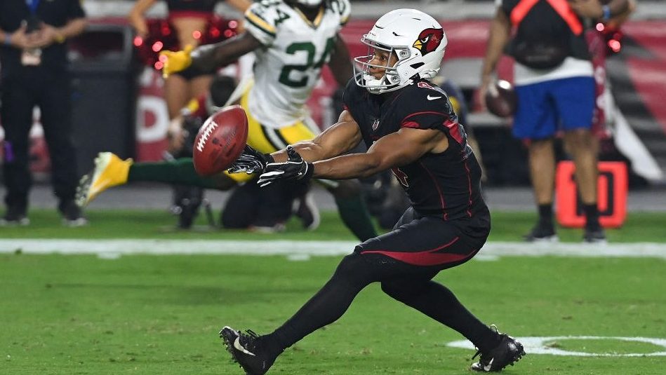 Rondale Moore #4 of the Arizona Cardinals fumbles a punt during the first half against the Green Ba...