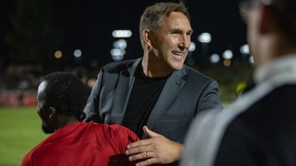 Phoenix Rising FC manager Rick Schantz celebrates winning the Pacific Division with captain Solomon...