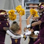 Arizona State quarterback Jayden Daniels (5) celebrates his touchdown run against Stanford with running back DeaMonte Trayanum (1) during the first half of an NCAA college football game Friday, Oct. 8, 2021, in Tempe, Ariz. (AP Photo/Ross D. Franklin)