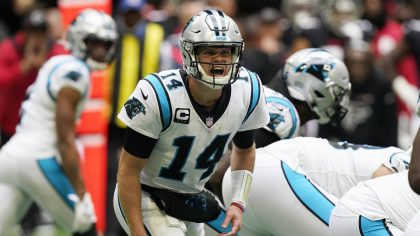 Carolina Panthers quarterback Sam Darnold (14) speaks during the first half of an NFL football game...