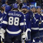 Tampa Bay Lightning goaltender Andrei Vasilevskiy (88) celebrates with teammates after the team defeated the Arizona Coyotes during an NHL hockey game Thursday, Oct. 28, 2021, in Tampa, Fla. (AP Photo/Chris O'Meara)