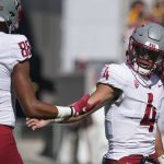 Washington State quarterback Jayden deLaura (4) gets congratulations from De'Zhaun Stribling (88) after scoring a touchdown against Arizona State during the first half of an NCAA college football game, Saturday, Oct 30, 2021, in Tempe, Ariz. (AP Photo/Darryl Webb)