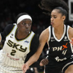 Chicago Sky forward Kahleah Copper (2) drives on Phoenix Mercury guard Skylar Diggins-Smith during the second half of Game 2 of basketball's WNBA Finals, Wednesday, Oct. 13, 2021, in Phoenix. The Mercury won 91-86 in overtime. (AP Photo/Rick Scuteri)