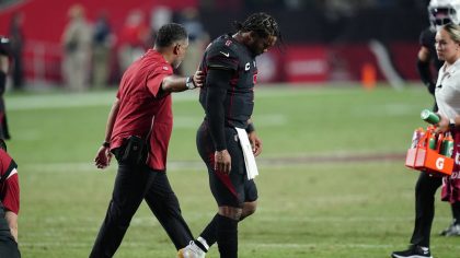 Arizona Cardinals quarterback Kyler Murray walks off the field after being hit during the second ha...