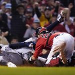 New York Yankees' Aaron Judge is tagged out at the plate by Boston Red Sox catcher Kevin Plawecki as he tries to score on a single by Giancarlo Stanton in the sixth inning of an American League Wild Card playoff baseball game at Fenway Park, Tuesday, Oct. 5, 2021, in Boston. (AP Photo/Charles Krupa)