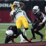 Green Bay Packers running back A.J. Dillon (28) is hit by Arizona Cardinals safety Budda Baker (3) during the first half of an NFL football game, Thursday, Oct. 28, 2021, in Glendale, Ariz. (AP Photo/Ross D. Franklin)