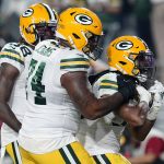 Green Bay Packers running back Aaron Jones, right, celebrates his touchdown with offensive tackle Elgton Jenkins (74) during the first half of an NFL football game against the Arizona Cardinals, Thursday, Oct. 28, 2021, in Glendale, Ariz. (AP Photo/Ross D. Franklin)