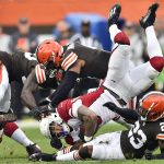 Arizona Cardinals running back James Conner, center, is tackled by Cleveland Browns middle linebacker Anthony Walker, top, and cornerback Troy Hill, bottom, during the first half of an NFL football game, Sunday, Oct. 17, 2021, in Cleveland. (AP Photo/David Richard)