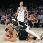 Chicago Sky forward Kahleah Copper (2) and Phoenix Mercury guard Sophie Cunningham, bottom, vie for a loose ball during the first half of Game 2 of basketball's WNBA Finals, Wednesday, Oct. 13, 2021, in Phoenix. (AP Photo/Rick Scuteri)
