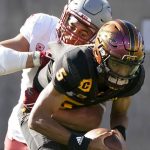 Washington State linebacker Ron Stone Jr. (10) wraps up Arizona State quarterback Jayden Daniels (5) for a loss during the second half of an NCAA college football game, Saturday, Oct 30, 2021, in Tempe, Ariz. (AP Photo/Darryl Webb)