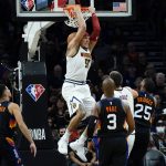 Denver Nuggets forward Aaron Gordon (50) dunks against the Phoenix Suns during the second half of an NBA basketball game, Wednesday, Oct. 20, 2021, in Phoenix. (AP Photo/Matt York)