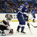 Tampa Bay Lightning right wing Taylor Raddysh (16) tries to deflect the puck past Arizona Coyotes goaltender Ivan Prosvetov (50) during the second period of an NHL hockey game Thursday, Oct. 28, 2021, in Tampa, Fla. (AP Photo/Chris O'Meara)