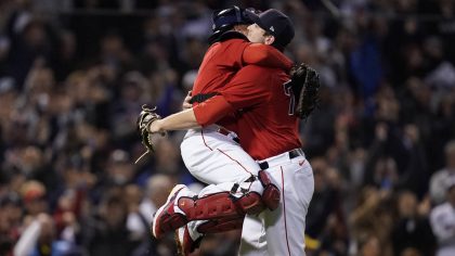 Boston Red Sox catcher Christian Vazquez, left, celebrates with relief pitcher Garrett Whitlock aft...