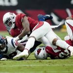 Arizona Cardinals outside linebacker Devon Kennard, right, and Arizona Cardinals linebacker Isaiah Simmons, center, tackle Houston Texans tight end Jordan Akins (88) during the first half of an NFL football game, Sunday, Oct. 24, 2021, in Glendale, Ariz. (AP Photo/Ross D. Franklin)