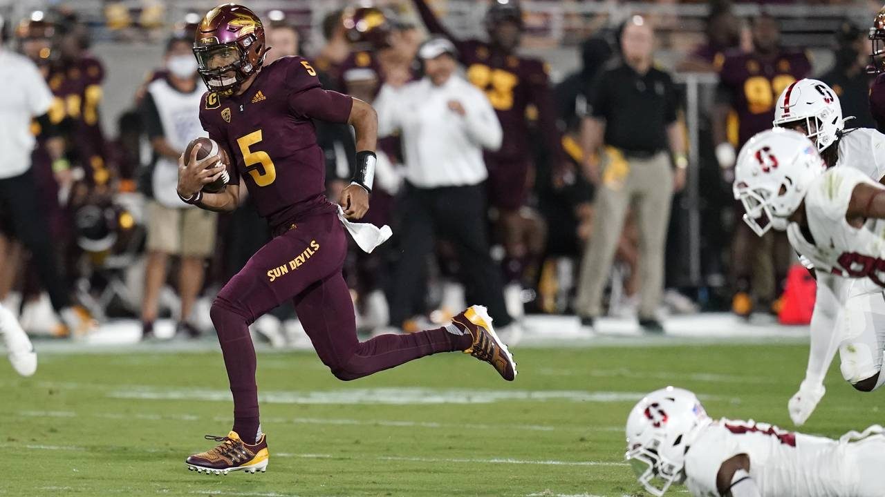 Arizona State quarterback Jayden Daniels (5) gets past the Stanford defense as he runs for a touchd...