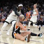Chicago Sky forward Kahleah Copper (2) and Phoenix Mercury guard Sophie Cunningham (9) compete for a loose ball during the first half of Game 2 of basketball's WNBA Finals, Wednesday, Oct. 13, 2021, in Phoenix. (AP Photo/Rick Scuteri)
