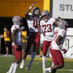 Washington State defensive back Jaylen Watson (0) celebrates his interception with Kaleb Ford Dement (23) against Arizona State during the second half of an NCAA college football game, Saturday, Oct 30, 2021, in Tempe, Ariz. (AP Photo/Darryl Webb)