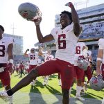 Washington State defensive back Chau Smith-Wade (6) celebrates their win over Arizona State with teammates De'Zhaun Stribling (88) and Simon Samarzich (34) at the end of an NCAA college football game, Saturday, Oct 30, 2021, in Tempe, Ariz. (AP Photo/Darryl Webb)