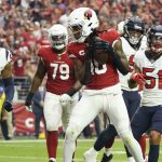 Arizona Cardinals wide receiver DeAndre Hopkins (10) scores a touchdown as Houston Texans middle linebacker Christian Kirksey (58) looks on during the first half of an NFL football game, Sunday, Oct. 24, 2021, in Glendale, Ariz. (AP Photo/Darryl Webb)