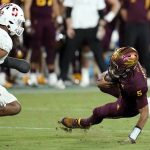 Arizona State quarterback Jayden Daniels (5) slips in front of Stanford linebacker Jacob Mangum-Farrar (14) during the second half of an NCAA college football game Friday, Oct. 8, 2021, in Tempe, Ariz. Arizona State defeated Stanford 28-10. (AP Photo/Ross D. Franklin)