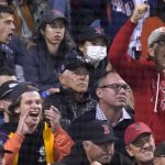 Former New York Yankees Bucky Dent (middle in Yankees cap) watches as Boston Red Sox fans cheer after Yankees' Brett Gardner struck out in the seventh inning of the American League Wild Card playoff game against the Boston Red Sox at Fenway Park, Tuesday Oct. 5, 2021 in Boston. (AP Photo/Charles Krupa)