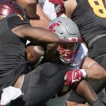 Washington State's Ron Stone Jr. (10) wraps up Arizona State running back DeaMonte Trayanum (1) during the first half of an NCAA college football game, Saturday, Oct 30, 2021, in Tempe, Ariz. (AP Photo/Darryl Webb)
