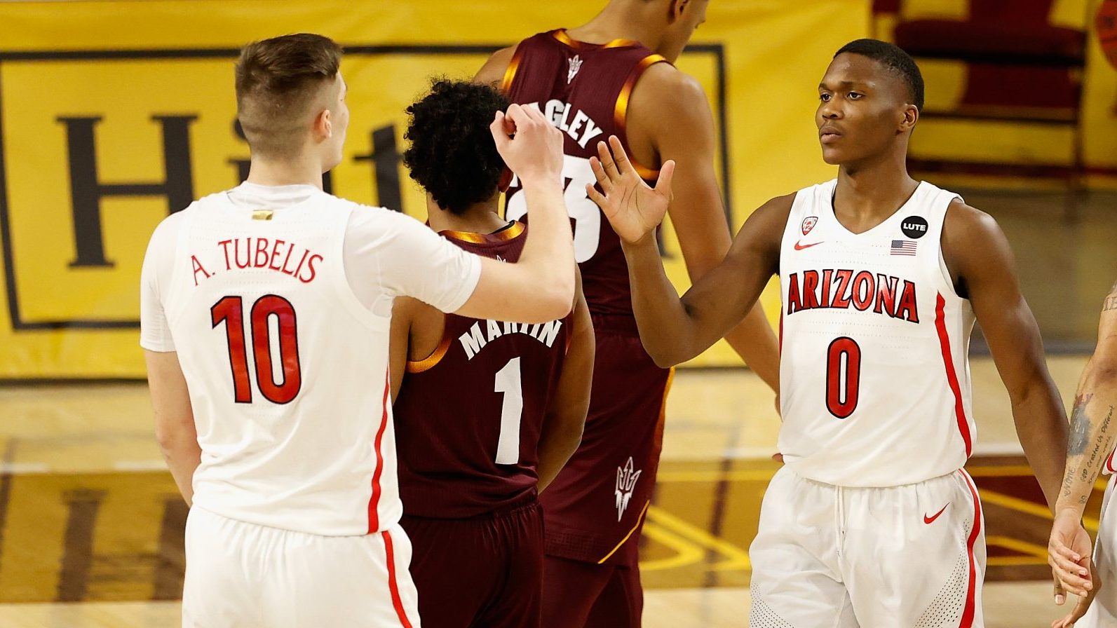 Bennedict Mathurin #0 of the Arizona Wildcats high fives Azuolas Tubelis #10 after a three-point sh...