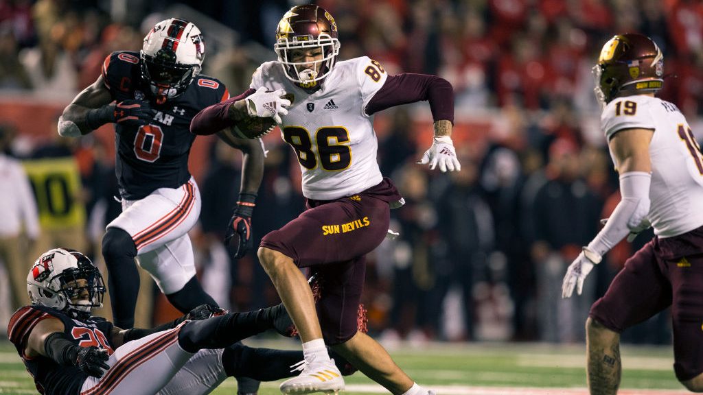 Curtis Hodges #86 of the Arizona State Sun Devils rushes the ball past Jaylen Dixon #25 and Devin L...