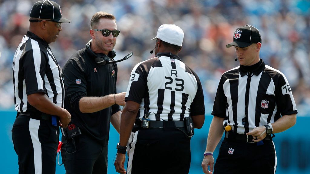 Head coach Kliff Kingsbury of the Arizona Cardinals speaks with referee Jerome Boger #23 during the...