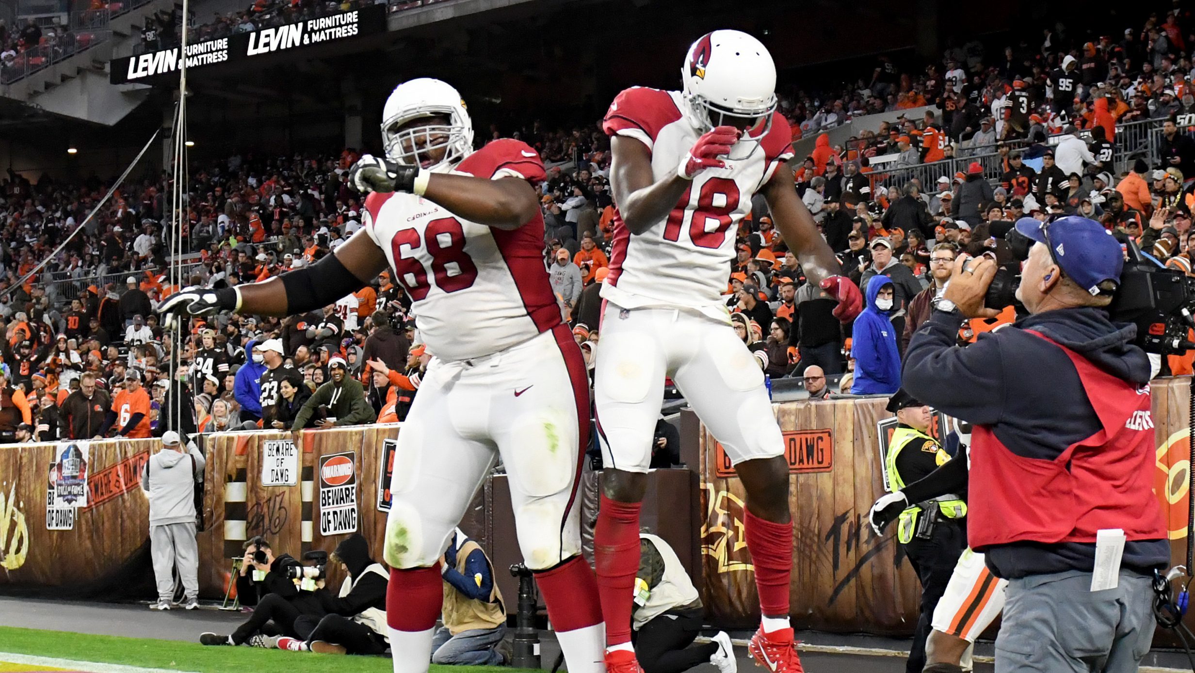 A.J. Green #18 of the Arizona Cardinals celebrates his touchdown reception with teammate Kelvin Bea...