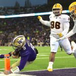 Dylan Morris #9 of the Washington Huskies dives to score a touchdown during the first quarter against the Arizona State Sun Devils at Husky Stadium on November 13, 2021 in Seattle, Washington. (Photo by Abbie Parr/Getty Images)
