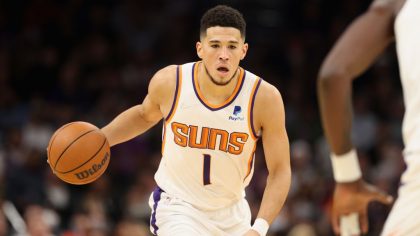 Devin Booker #1 of the Phoenix Suns handles the ball during the first half of the NBA game at Footp...