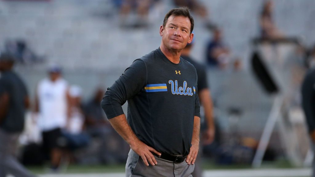 Head coach Jim Mora of the UCLA Bruins watches warm ups before the college football against the Ari...
