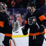 Philadelphia Flyers' Keith Yandle, right, and Carter Hart celebrate after an NHL hockey game against the Arizona Coyotes, Tuesday, Nov. 2, 2021, in Philadelphia. (AP Photo/Matt Slocum)